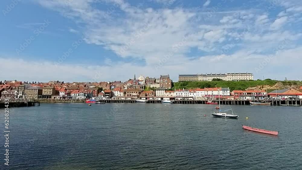 Panning shot of Whitby harbour and the Grade 2 listed Tate Hill Pier on the North Yorkshire Coast. Captured on a bright and sunny summer day Panning shot of Whitby harbour and the Grade 2 listed Tate Hill Pier on the North Yorkshire Coast. Captured on a bright and sunny summer day