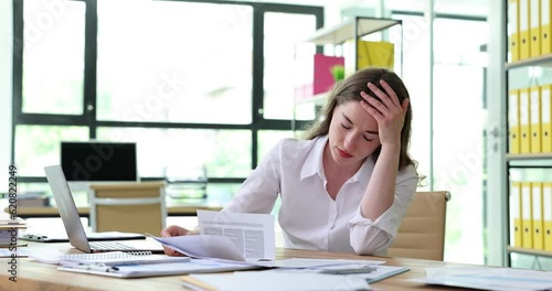 Frustrated businesswoman entrepreneur reading letter with bad news about project failure or bankruptcy in office. Sad manager or seo bankruptcy letter