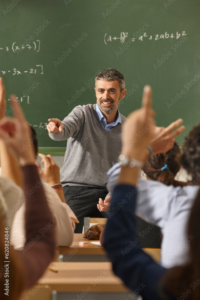 Math teacher giving lessons. Classroom with students. Elementary education