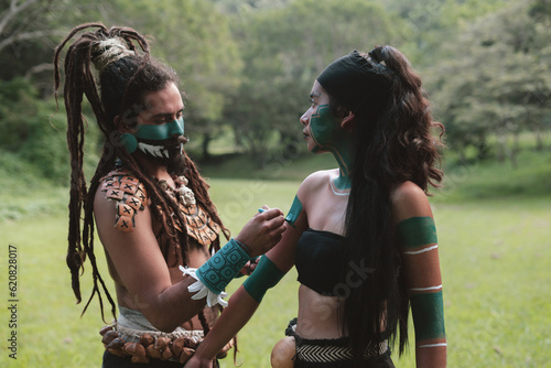 Native man and woman painting their skin photo