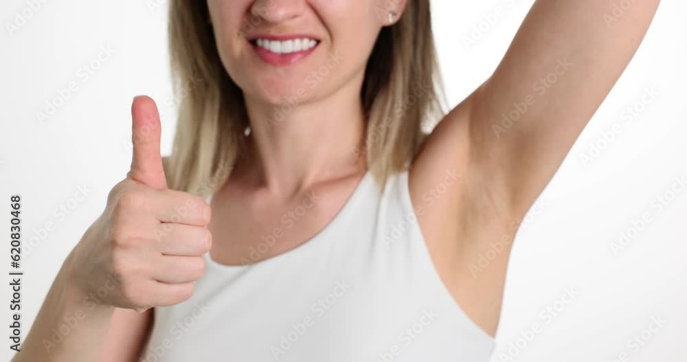 Smiling woman with smooth armpit and thumbs up. Positive trend for body and acceptance of naturalness of body Smiling woman with smooth armpit and thumbs up. Positive trend for body and acceptance of naturalness of body