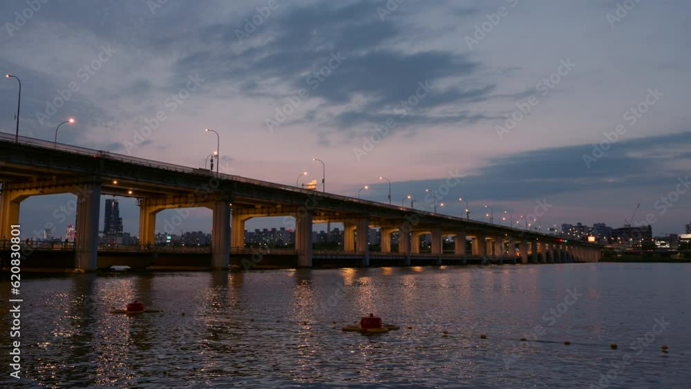 Night Illumination and Cars Traffic on Banpo Bridge over Han River At Stunning Sunset Sunlight Reflections in Water - static realtime Night Illumination and Cars Traffic on Banpo Bridge over Han River At Stunning Sunset Sunlight Reflections in Water - static realtime
