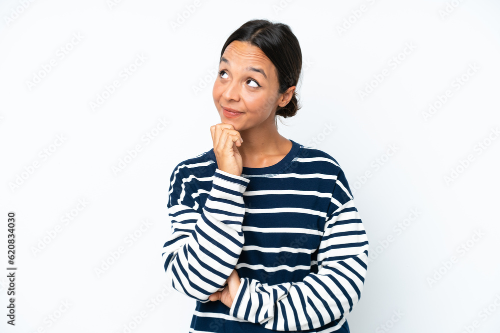 Young hispanic woman isolated on white background and looking up Young hispanic woman isolated on white background and looking up
