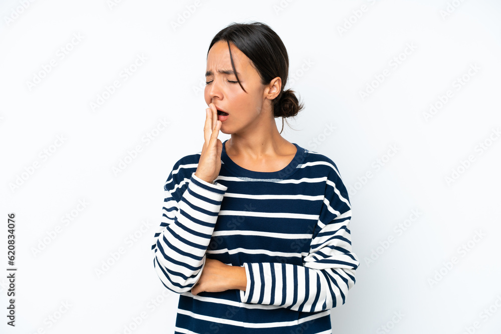 Young hispanic woman isolated on white background yawning and covering wide open mouth with hand Young hispanic woman isolated on white background yawning and covering wide open mouth with hand