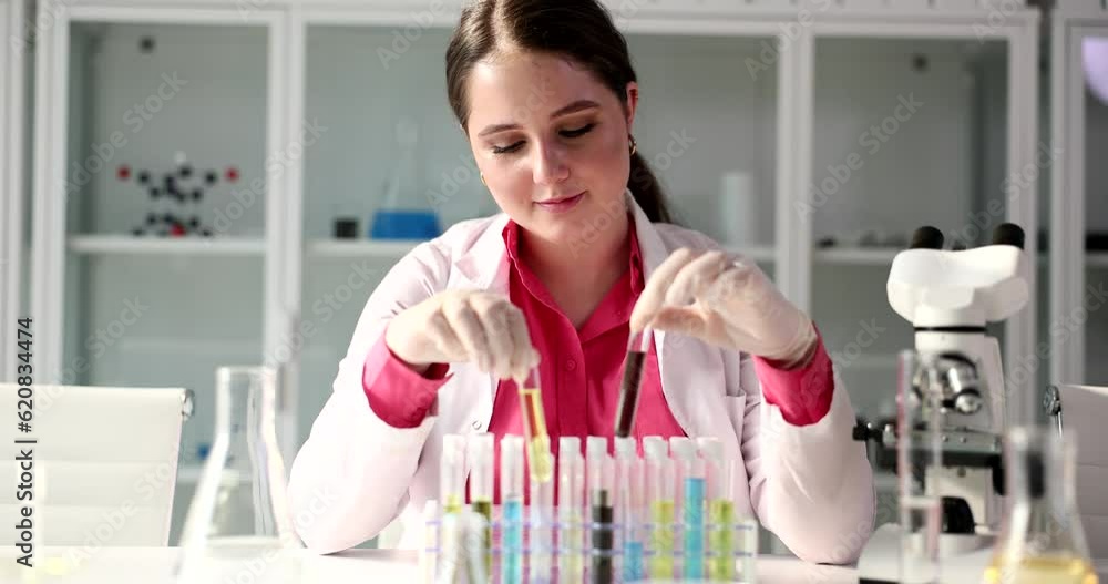 Scientist examines test tubes with liquid sample in laboratory. Chemical properties of toxic liquids