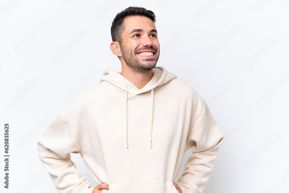 Young caucasian man isolated on white background posing with arms at hip and smiling Young caucasian man isolated on white background posing with arms at hip and smiling
