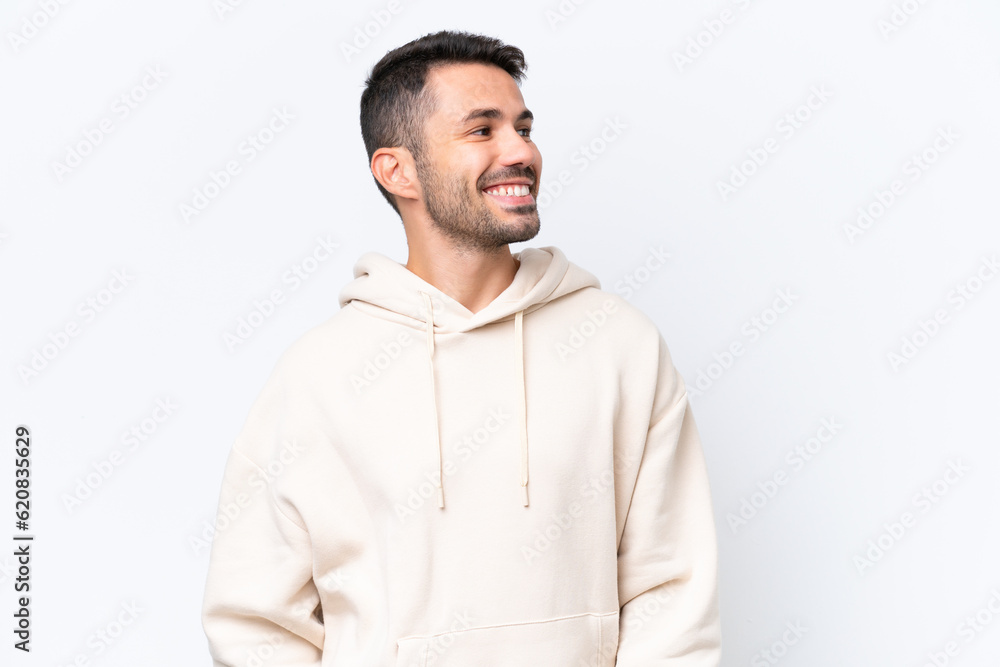 Young caucasian man isolated on white background looking to the side and smiling Young caucasian man isolated on white background looking to the side and smiling