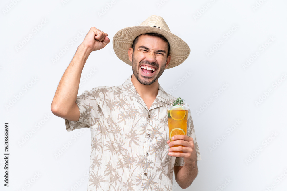 Young caucasian man holding a cocktail isolated on white background celebrating a victory Young caucasian man holding a cocktail isolated on white background celebrating a victory