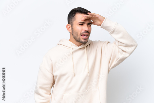 Young caucasian man isolated on white background looking far away with hand to look something © luismolinero