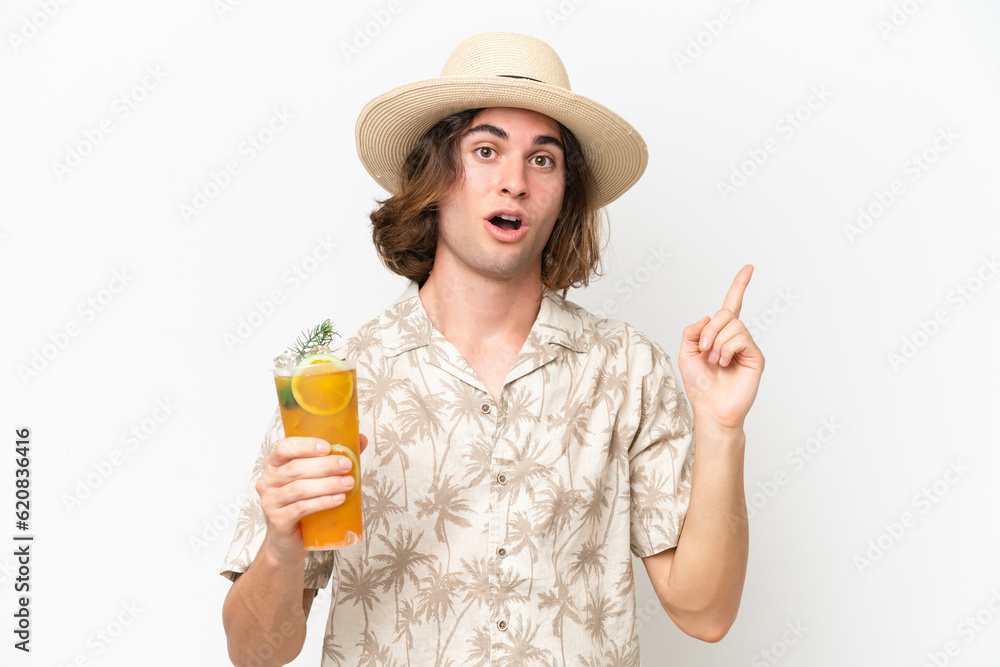 Young handsome man holding a cocktail isolated on white background intending to realizes the solution while lifting a finger up Young handsome man holding a cocktail isolated on white background intending to realizes the solution while lifting a finger up