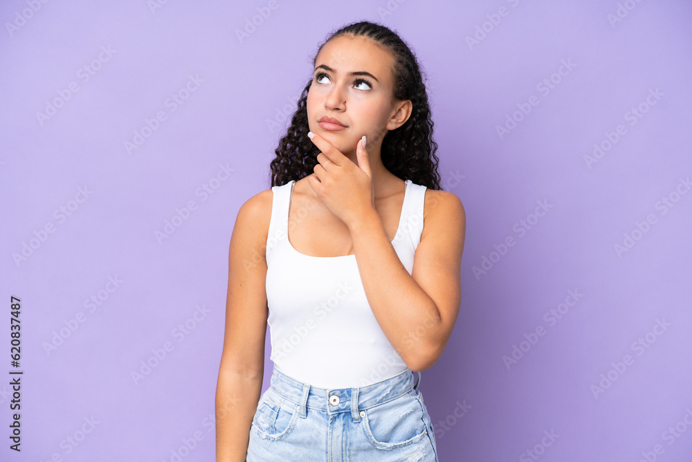 Young woman isolated on purple background having doubts Young woman isolated on purple background having doubts