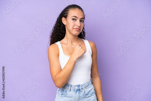 Young woman isolated on purple background proud and self-satisfied