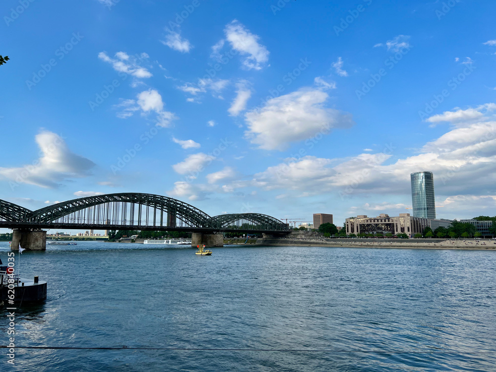 The shore of Rhine river and the Hohenzollernbrücke bridge in COlogne, Germany.