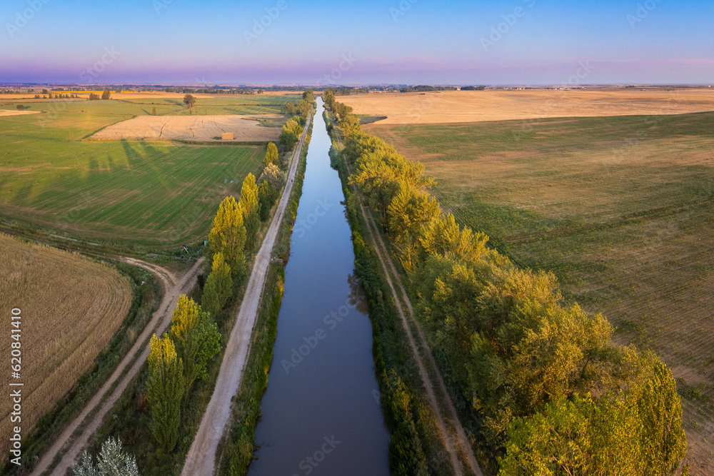 Enchanting Sunrise Over the Scenic Canal de Castilla: An Aerial Perspective