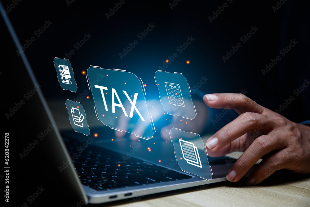 income tax concept. Businessman pointing to tax icon. income tax system icon around. pay online income tax. futuristic virtual screen interface technology. income tax concept. Businessman pointing to tax icon. income tax system icon around. pay online income tax. futuristic virtual screen interface technology.