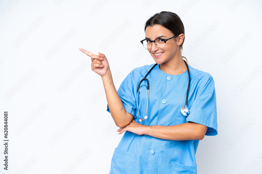 Young nurse woman isolated on white background pointing finger to the side Young nurse woman isolated on white background pointing finger to the side