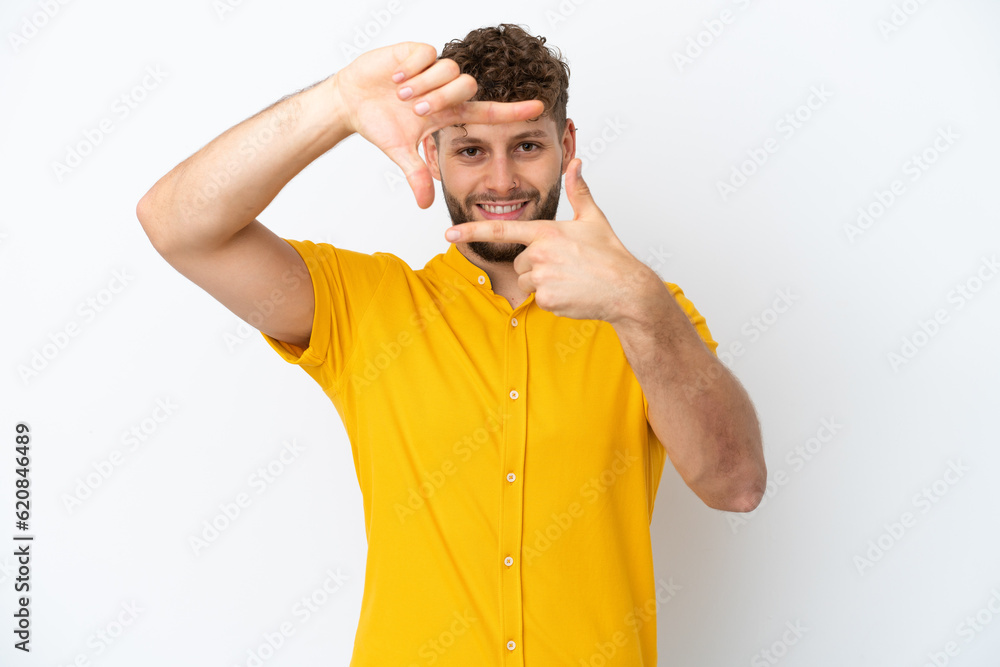 Young handsome caucasian man isolated on white background focusing face. Framing symbol Young handsome caucasian man isolated on white background focusing face. Framing symbol