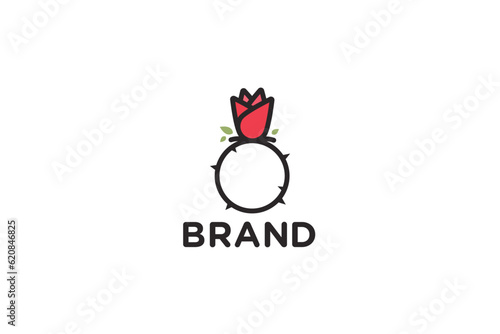 Creative logo design depicting a ring with a thorned rose, designated for the fashion or apparel industry.