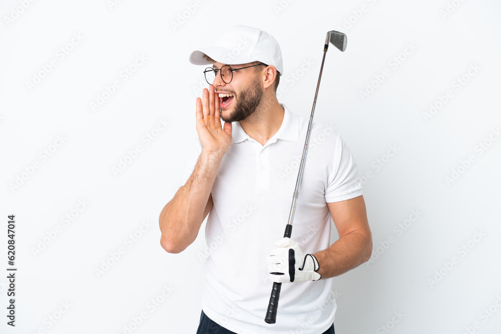 Handsome young man playing golf isolated on white background shouting with mouth wide open to the side Handsome young man playing golf isolated on white background shouting with mouth wide open to the side