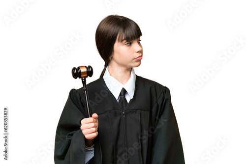 Little girl playing as a Judge over isolated background looking to the side photo