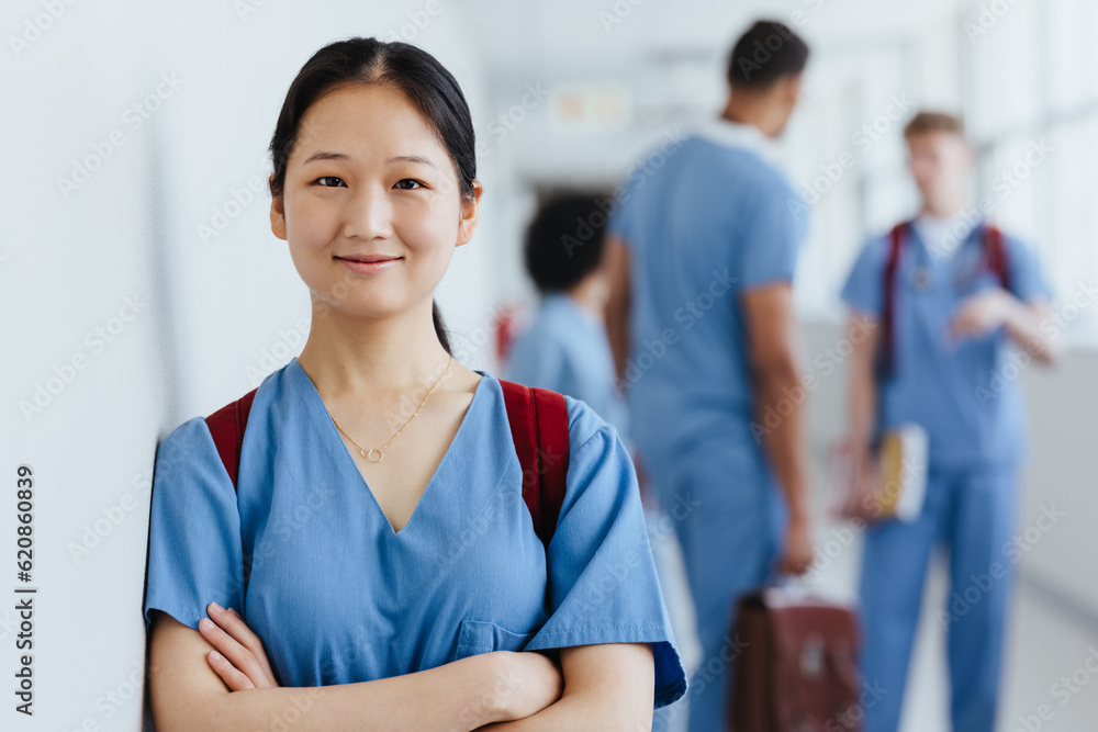 © Jacob Lund - Asian nursing student wearing scrubs in a hospital during training