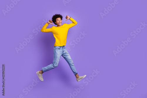 Full body size cadre of young man jumping directing fingers himself best football player achievement isolated on violet color background