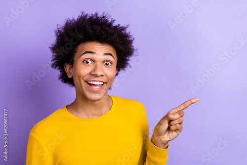 Photo of funny guy advertise his new product in social media propaganda direct finger surprised novelty isolated on purple color background