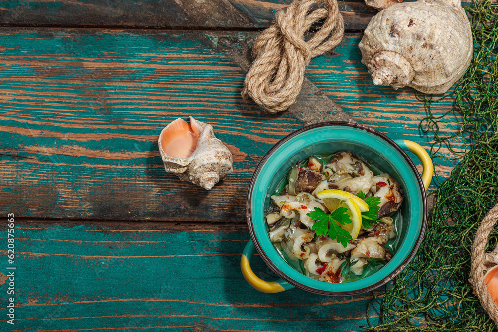 Rapana clam meat with oil, spices and greens. Healthy seafood rich of omega. Marine decor Rapana clam meat with oil, spices and greens. Healthy seafood rich of omega. Marine decor