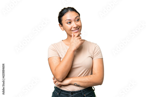 Young Uruguayan woman over isolated chroma key background looking to the side and smiling