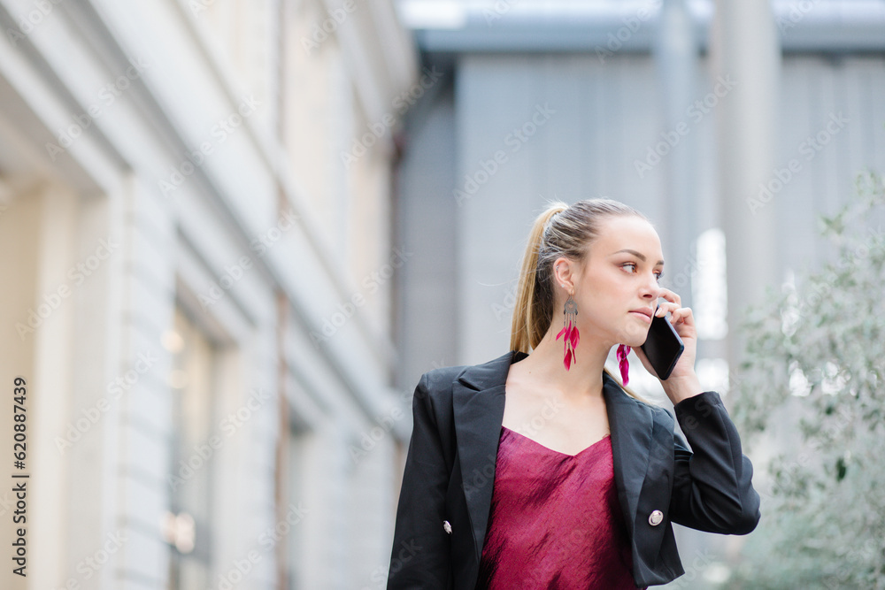 Businesswoman on phone walking around town Businesswoman on phone walking around town