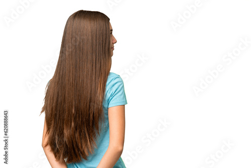 Teenager girl over isolated chroma key background in back position and looking back