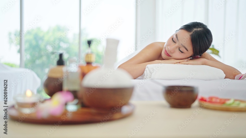 Beautiful young asian woman in towel lying on spa bed waiting spa treatment in weekend at spa salon. Therapy, Body care concept 