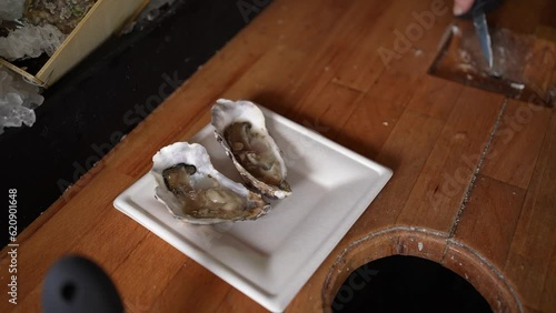 Serving oyster at a food truck onto a paper tray