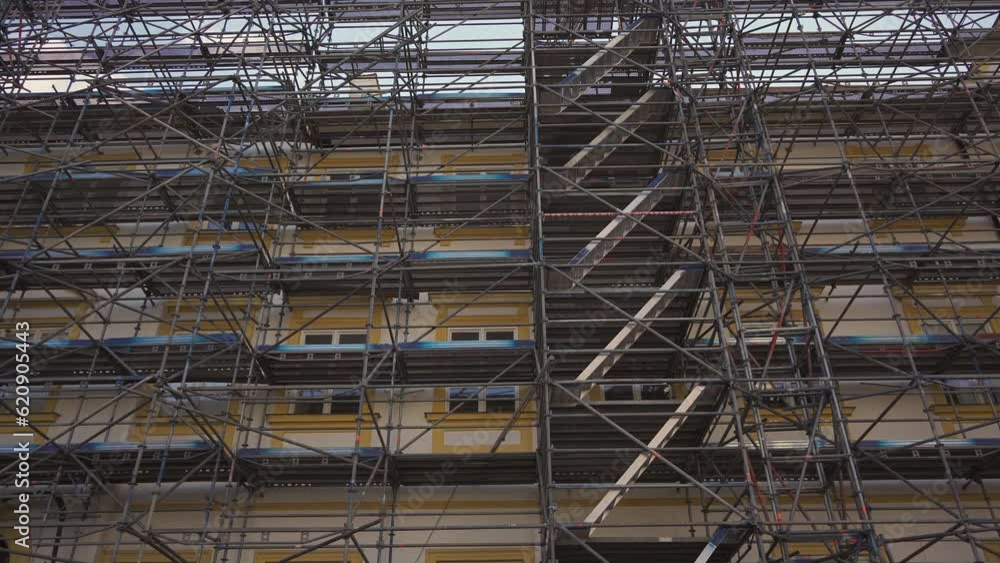 Scaffolding on old building in Europe, restored historic building, details of facade. Restoration industry, old architecture, real estate renovation, no people. scaffolding building under construction Scaffolding on old building in Europe, restored historic building, details of facade. Restoration industry, old architecture, real estate renovation, no people. scaffolding building under construction