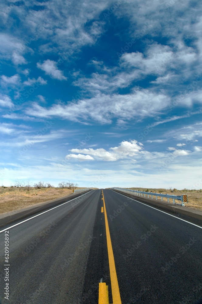 Desert Serenity: Panoramic View of an Empty Road Surrounded by Red Rock Canyon After a Storm, Presented in Captivating 4K Resolution