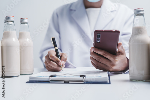 Quality control laboratory dairy factory professional people checking milk bottles quality  Dairy factory industry products.