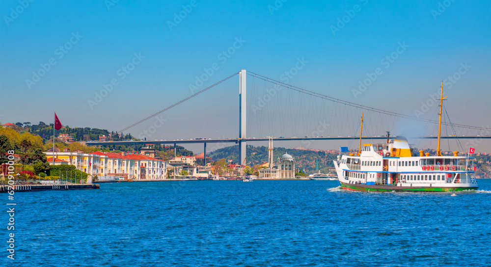 Sea voyage with old ferry (steamboat) on the Bosporus - Ortakoy mosque and Bosphorus bridge - Istanbul, Turkey  