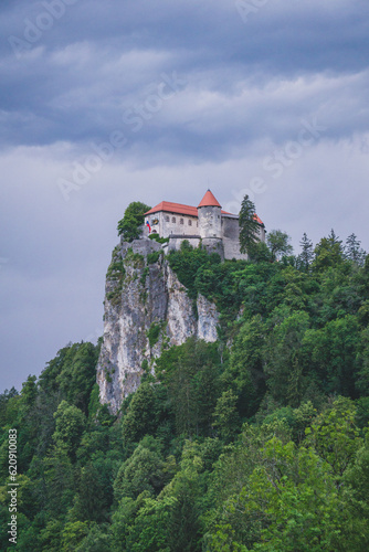 Bled castle at sunset on a cloudy day with purple tones