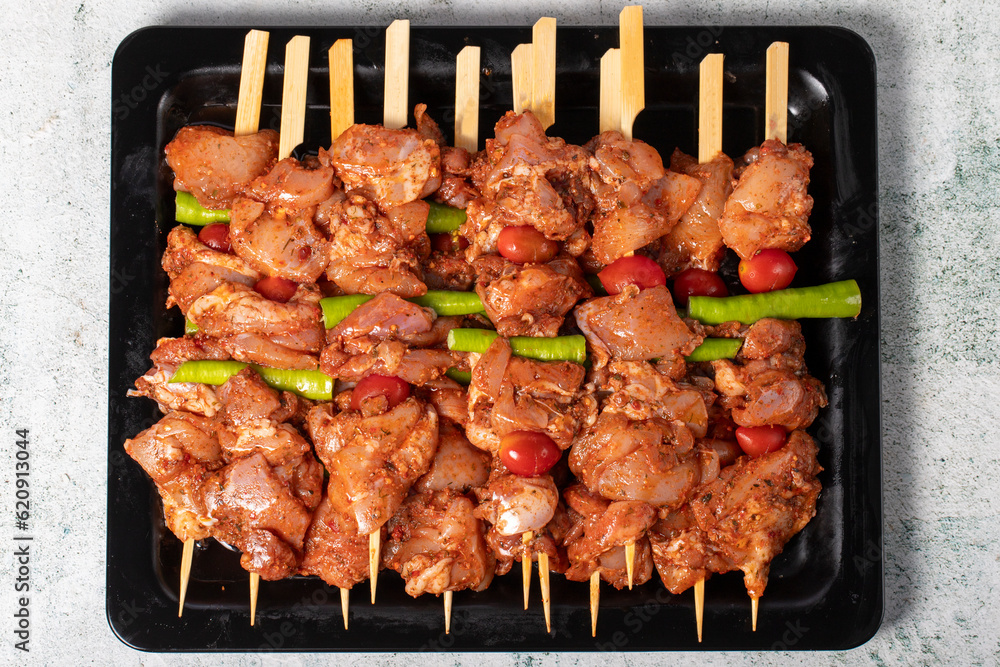 Chicken skewer. Chicken skewers with raw sauce on gray background. Top view Chicken skewer. Chicken skewers with raw sauce on gray background. Top view