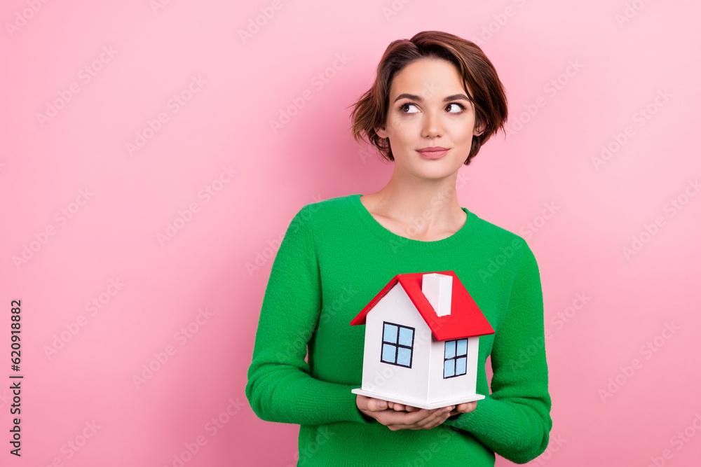 Photo of thoughtful young real estate agent mortgage rent house apartment hold building look empty space isolated on pink color background Photo of thoughtful young real estate agent mortgage rent house apartment hold building look empty space isolated on pink color background