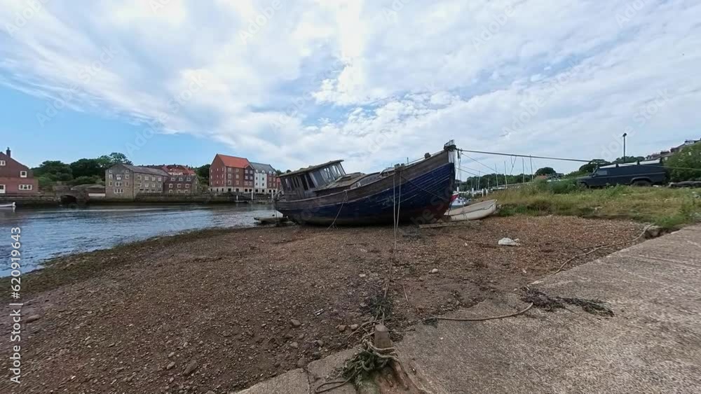 Old, wooden dilapidated boat moored on the bank of the River Esk in the seaside town of Whitby on the North Yorkshire Coast Old, wooden dilapidated boat moored on the bank of the River Esk in the seaside town of Whitby on the North Yorkshire Coast