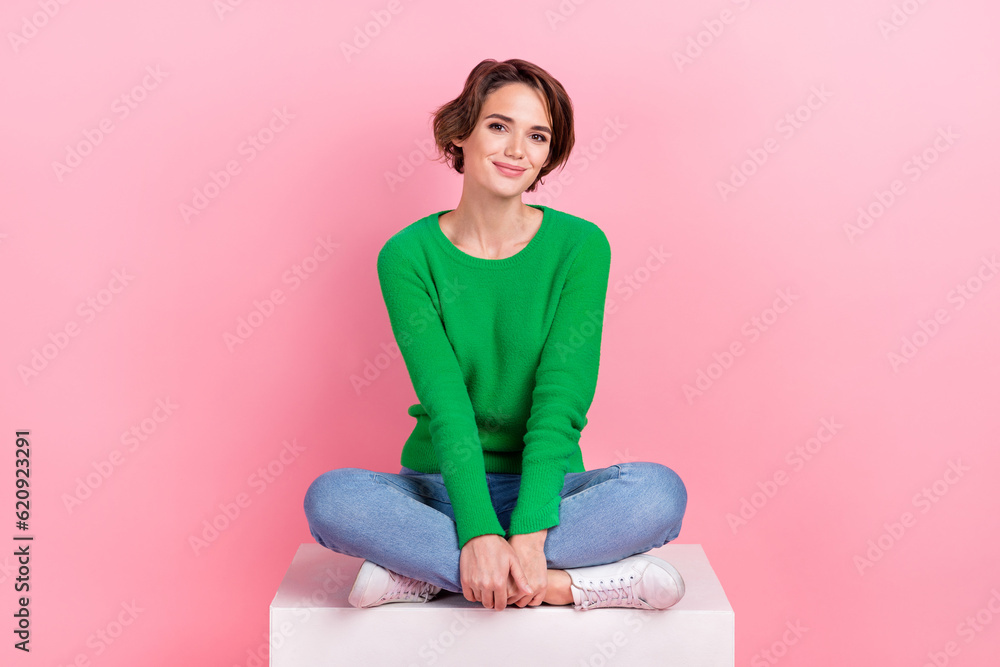 Full body length cadre of young cute pretty business lady sitting podium crossed legs comfortable place isolated on pink color background