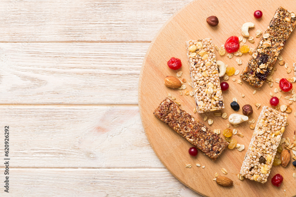 Various granola bars on table background. Cereal granola bars. Superfood breakfast bars with oats, nuts and berries, close up. Superfood concept Various granola bars on table background. Cereal granola bars. Superfood breakfast bars with oats, nuts and berries, close up. Superfood concept