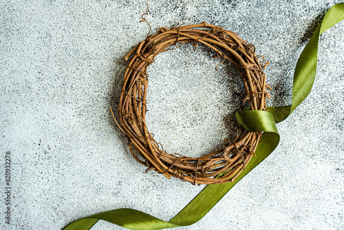 Overhead view of  a festive grapevine Wreath with a green ribbon photo
