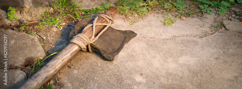 Фотография Stone ax of a primitive man