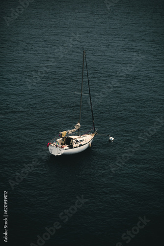 a beautiful sailboat in the center, in the middle of the ocean © Eliott
