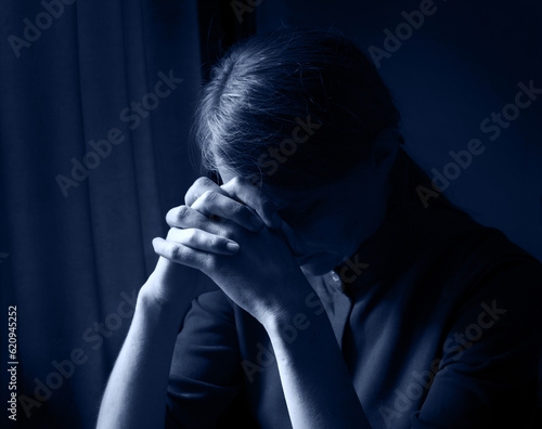 Praying woman at the window