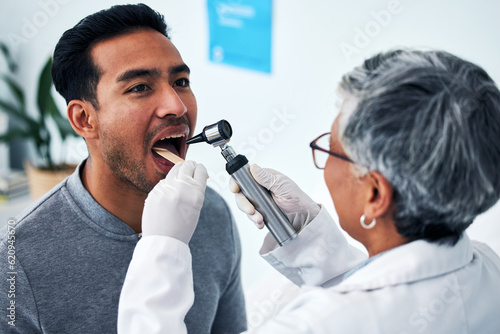 Healthcare, consulting and doctor with person and throat in hospital for cancer, sick and surgery. Medicine, medical and check up with woman and patient in clinic for wellness, virus and mouth exam photo