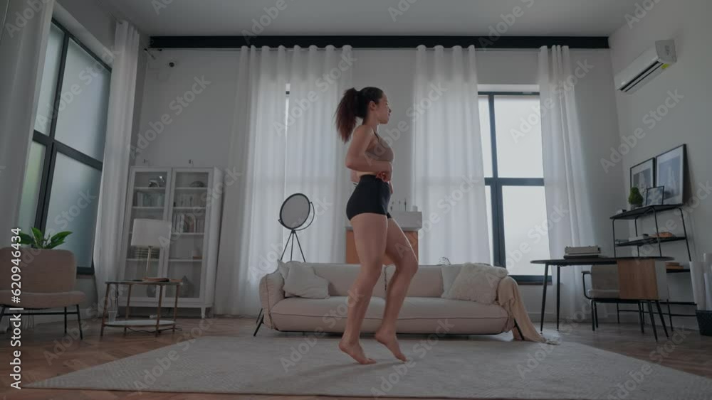 smiling brunette dancing in apartment happy active day at home smiling brunette dancing in apartment happy active day at home