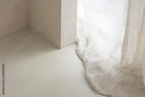 beige background with light and shadow of window curtains